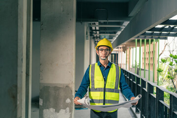 Wall Mural - Portrait Asian man Builder holding blueprint in construction site. Foreman inspection working with blueprint in construction site.