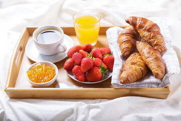 Wall Mural - Breakfast in bed. Tray with cup of coffee, orange juice, fresh fruits