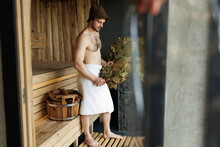 Muscular Attractive Man With Brooms In The Sauna