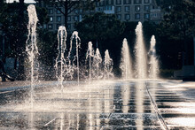 Fountain In The Rays Of The Sun In A Modern Park In The City