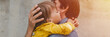 © Ksenia - man dad having quality time with their kid son boy six year old hug on arms. happy father playing together child. real life authentic day-to-day fatherhood moments. fatherly love care. banner. flare