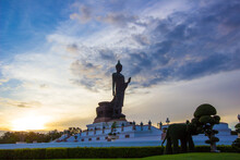 Sunset Sky And Buddha Statue At  Phutthamonthon,a Buddhist Park In Nakhon Pathom Province Of Thailand.Non-English Language At The Base Is The Name Of The Statue "Phra Si Sakkaya Thotsaphonlayan"
