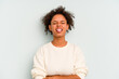 © Asier - Young Brazilian woman isolated on blue background funny and friendly sticking out tongue.