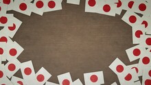 Frame Made Of Paper Flags Of Japan Arranged On Wooden Table. National Celebration Concept. 3D Illustration