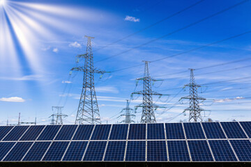 Solar panels, high voltage electricity towers, and sun rays