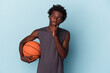 © Asier - Young african american man playing basketball isolated on blue background looking sideways with doubtful and skeptical expression.