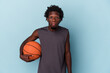 © Asier - Young african american man playing basketball isolated on blue background shrugs shoulders and open eyes confused.
