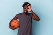 © Asier - Young african american man playing basketball isolated on blue background excited keeping ok gesture on eye.
