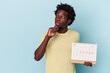 © Asier - Young african american man holding calendar isolated on blue background looking sideways with doubtful and skeptical expression.