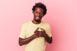 © Asier - Young african american man isolated on pink background has friendly expression, pressing palm to chest. Love concept.