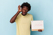 © Asier - Young african american man holding calendar isolated on blue background trying to listening a gossip.