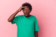 © Asier - Young african american man isolated on pink background looking far away keeping hand on forehead.