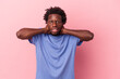 © Asier - Young african american man isolated on pink background touching back of head, thinking and making a choice.