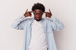 © Asier - Young african american man isolated on white background  focused on a task, keeping forefingers pointing head.