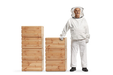 Sticker - Full length portrait of a bee keeper standing with wooden boxes