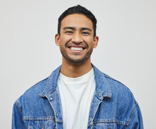 Its A Good Day To Smile. Cropped Portrait Of A Handsome Young Man Posing In Studio Against A Grey Background.