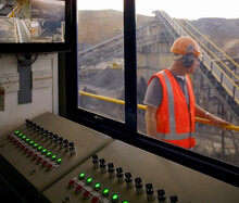 Man Walking Past Control Room In Quarry