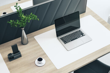 Close up and top view of creative wooden designer workplace with empty mock up laptop computer screen with reflections, partition, coffee cup, decorative plant and supplies. 3D Rendering.