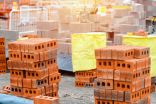 Red Bricks And Concrete Blocks Delivered On Construction Site And Placed Next To Place Of Work Ready For Bricklayers