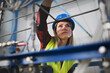 © Halfpoint - Portrait of female engineer working in industrial factory