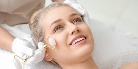 Sticker - Young woman having facial massage in beauty salon