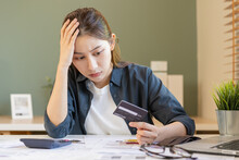 Financial Owe, Hand Of Asian Woman Sitting, Holding Many Credit Card, Stressed  By Calculate Expense From Invoice Or Bill, No Money To Pay, Mortgage Or Loan. Debt, Bankruptcy Or Bankrupt