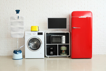 Wall Mural - Modern household appliances near white brick wall in room