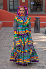 Wall Mural - Portrait of a Mexican woman wearing a traditional dress for folk dance