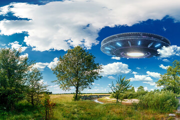 Wall Mural - ufo, an alien saucer hovering over the field, hovering motionless in the air. unidentified flying ob