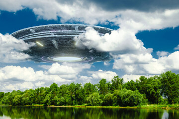 Wall Mural - ufo, an alien saucer hovering over the field, hovering motionless in the air. unidentified flying ob