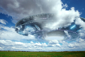 Wall Mural - ufo, an alien saucer hovering above the field in the clouds, hovering motionless in the sky. unident