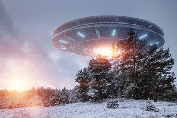 Wall Mural - ufo, alien saucer hovering over the winter landscape in the sky. unidentified flying object, alien i