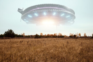 Wall Mural - ufo, an alien saucer hovering above the field in the clouds, hovering motionless in the sky. unident