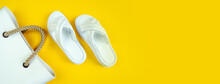 Women's Summer White Slippers And A White Rubber Bag With Brown Handles On A Yellow Background. Slippers. Banner For Insertion Into Site. Place For Text Cope Space. Horizontal Image