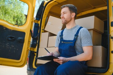 Canvas Print - young delivery man courier in uniform hold documents clipboard checking list parcel post boxes near a car for service shipment to customer, Online shopping service concepts.