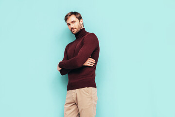 portrait of handsome confident stylish hipster lambersexual model. sexy man dressed in turtleneck sw