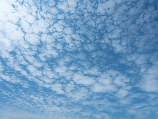 Wall Mural - deep blue skies with white clouds background with space for text, blue cloudy skies texture. front v
