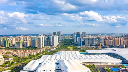 Wall Mural - Aerial Hyperlapse of Haikou City Western Coast, with Hainan International Convention And Exhibition Center, Office Buildings, Residential Apartmentsin the View.