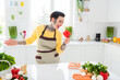 Photo of young carefree good mood female with piercing tattoo have fun in kitchen singing song with bell pepper