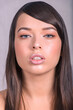 Very Tight Close-up of Beautiful Caucasian Woman With Cat Blue Eyes, Full Shinny Lips and Open Mouth on Grey Background
