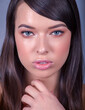 Very Tight Close-up of Beautiful Caucasian Woman With Cat Blue Eyes, Full Shinny Lips and Open Mouth on Blue Background