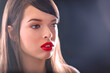 Semi-profile of Beautiful Caucasian Woman With Cat Blue Eyes, Full Red Lips and Open Mouth Looking Away on Grey Empty Background