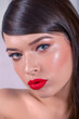 Close-up of a Beautiful Caucasian Woman With Cat Blue Eyes, Full Red Lips and Open Mouth on Grey Background