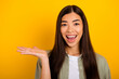 Photo of adorable good mood overjoyed female recommend suggest product isolated on yellow color background