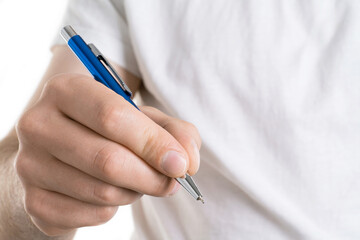 A close up image of Man's hand holds a pen isolated on white background. He is signing a form