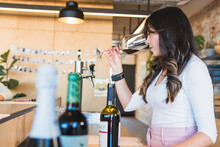 Woman Smelling Drinks During Wine Tasting Session