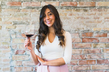 Stylish Female Sommelier With Red Wine