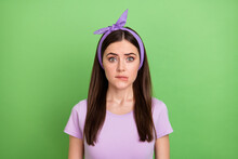 Photo Of Scared Nervous Lady Dressed Purple T-shirt Hairband Biting Lip Isolated Green Color Background