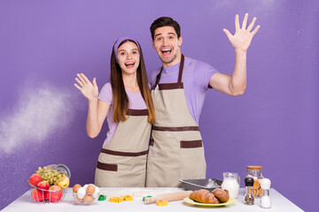 Canvas Print - Photo of two funky cheerful people raise arms palm throw wheat make dough isolated on violet color background