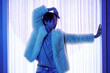 © Seventyfour - Waist up portrait of extravagant Asian man entering stage at vogue dance party in blue neon light